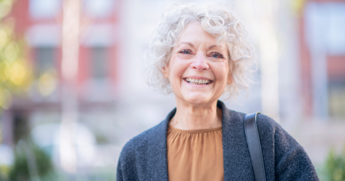 A woman is happy as a result of successfully dealing with senior incontinence.