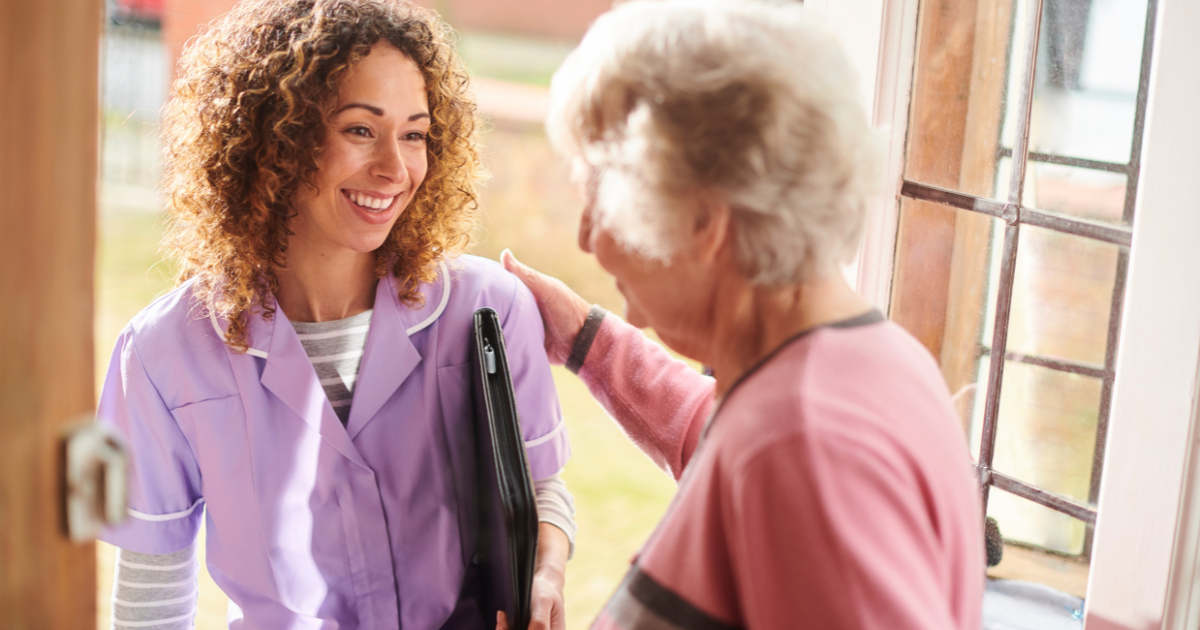 A caregiver enters a senior client's home to provide respite care services.