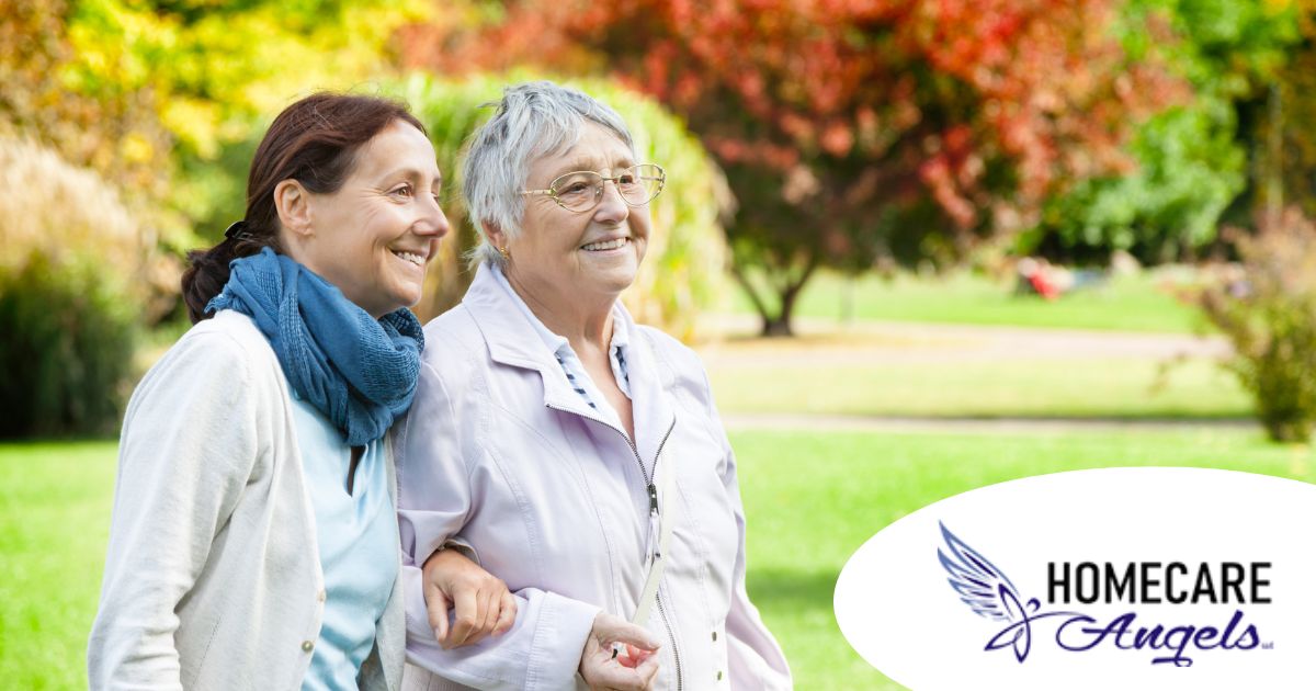 A recently retired woman enjoys her caregiving job as she walks with a senior client outside.