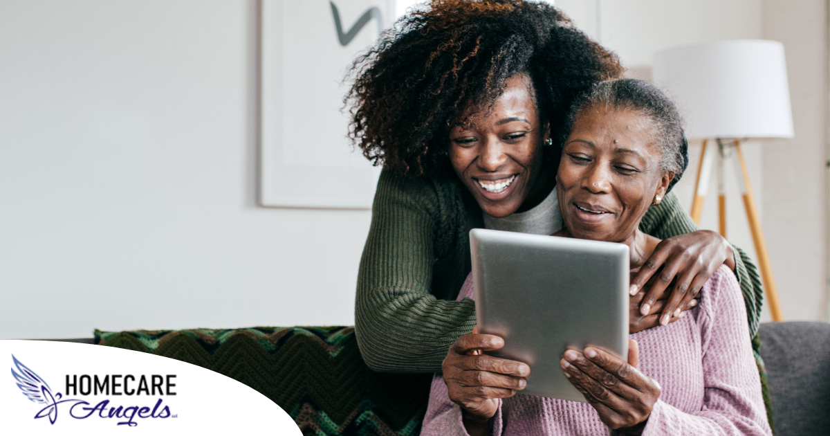 A caregiver helps a senior with her tablet, representing the rise of technology in home care.