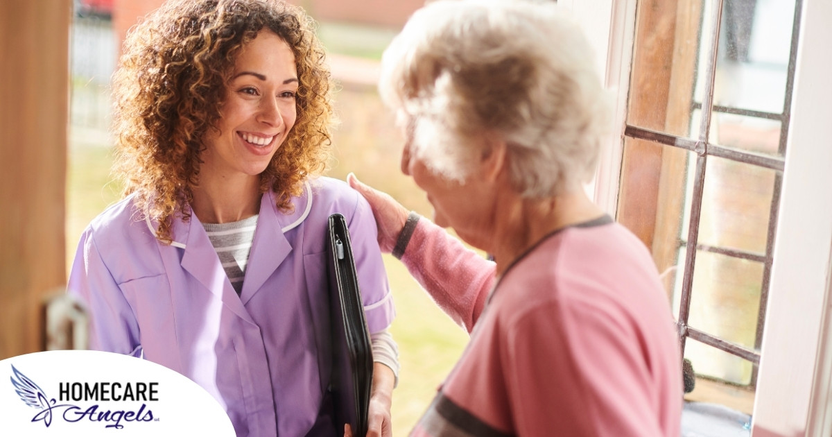 A happy caregiver enters the home of a client, representing in-home recovery care.