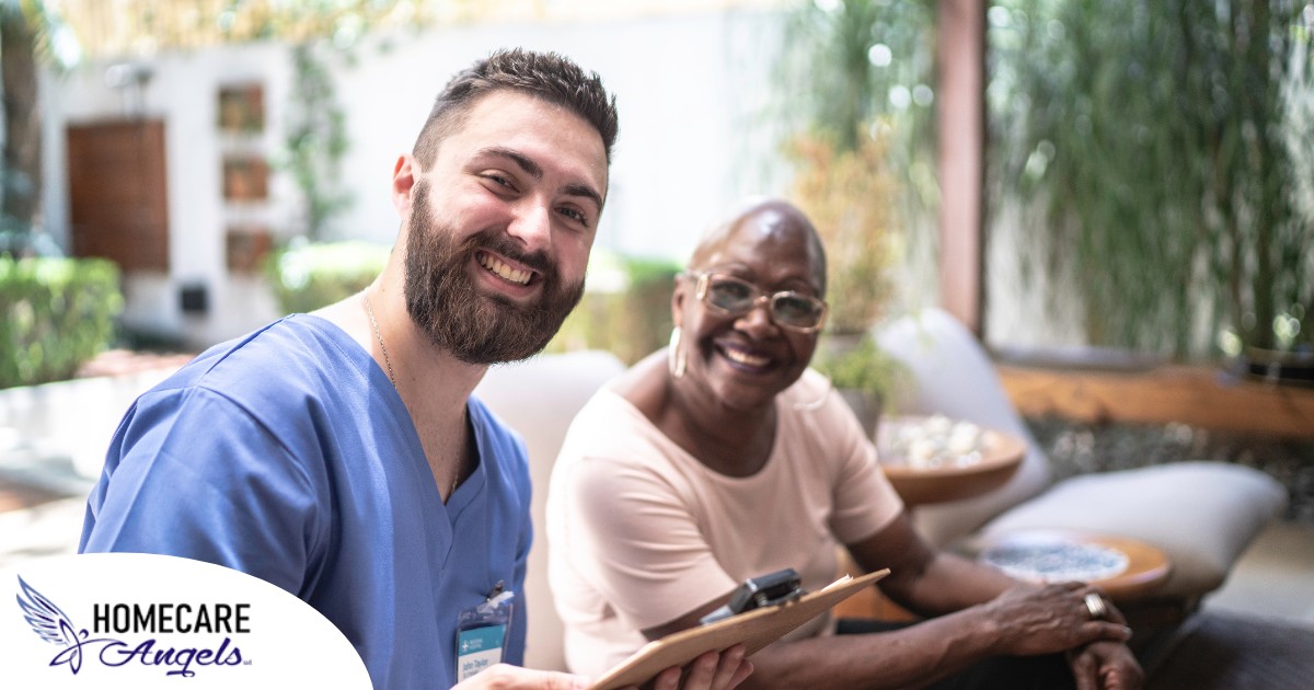 A man enjoys his caregiver job as he works with a client.