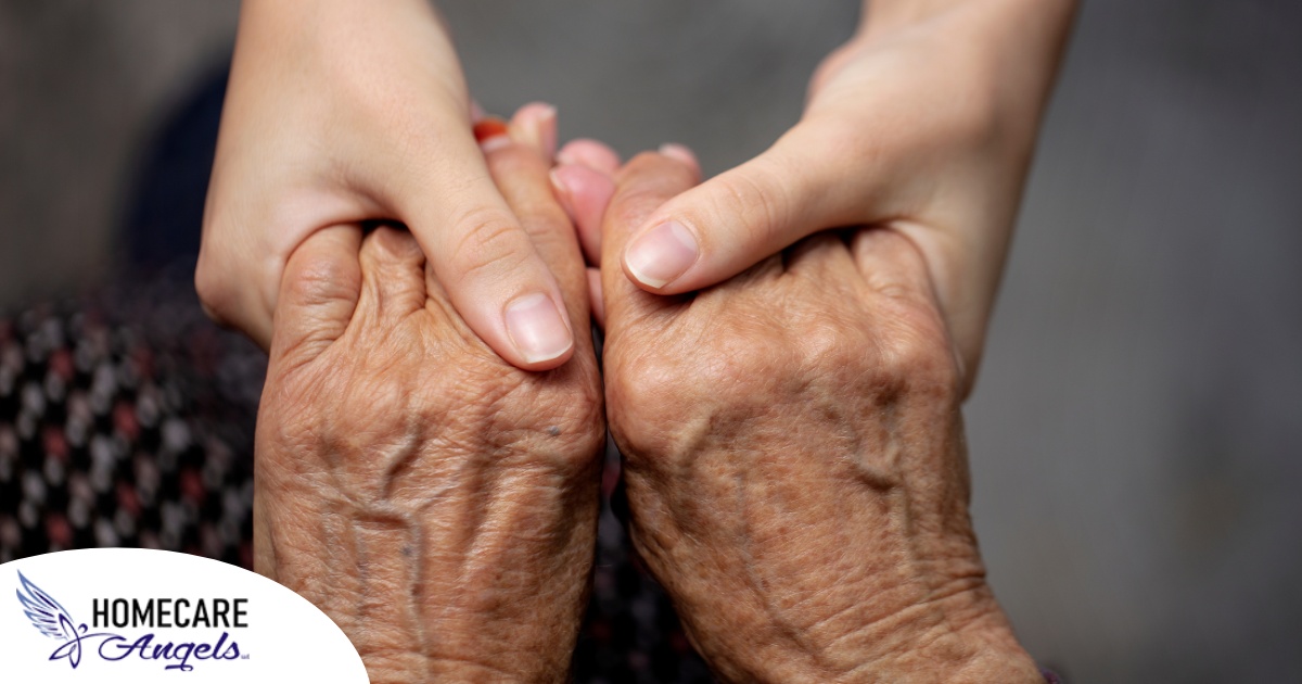 Younger hands hold older ones, representing the care and compassion of caregiving and how caregivers can help, even in ways like implementing stroke prevention strategies.