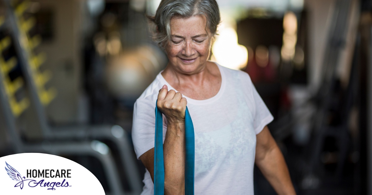 An older woman uses a resistance band to exercise, representing how staying active can help older adults keep their blood pressure in a healthy range.