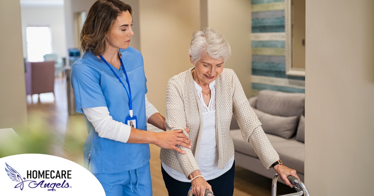 A professional caregiver helps an older client with a walker get around.