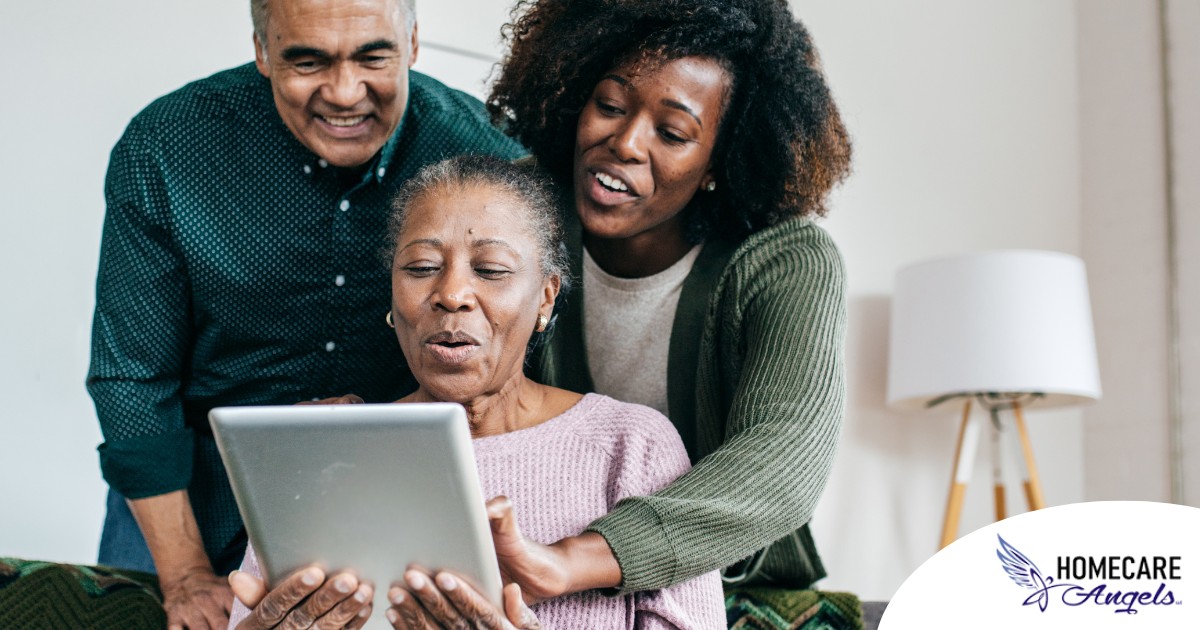 A daughter looks at a tablet with her older parents, representing technology and how ti can help with aging in place.