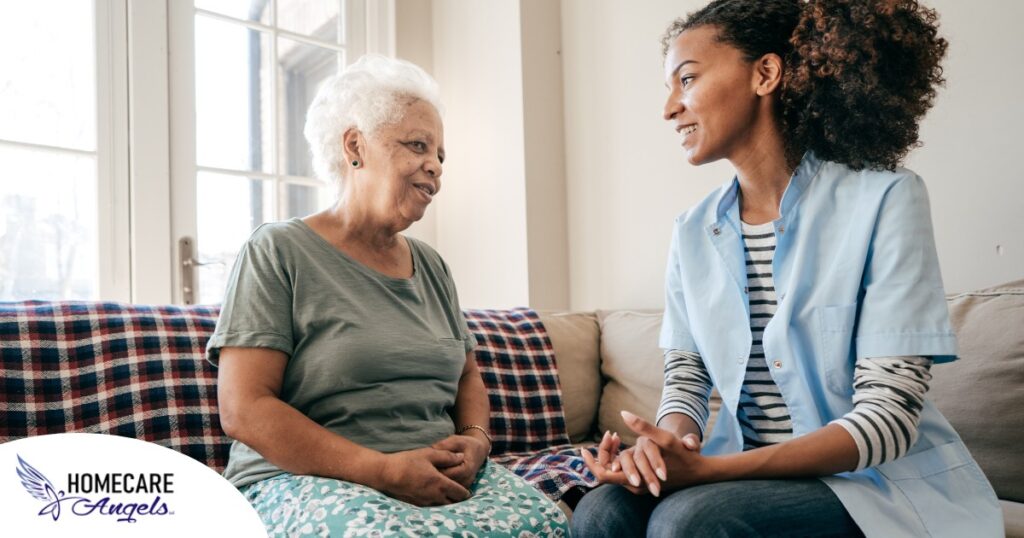 A caregiver sits and spends time with a client, representing how non-medical home care can benefit older loved ones.